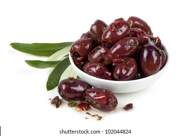 Bowl Of Marinated Kalamata Olives With Olive Leaves, Isolated On White.