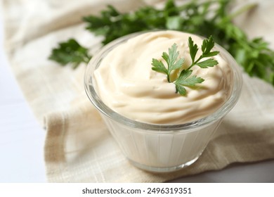 Bowl with mayonnaise on wooden background