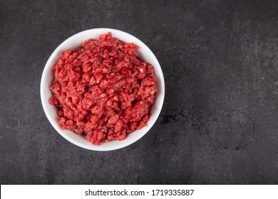 A Bowl Of Minced Meat On Black Background