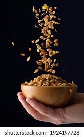 Bowl With Muesli In Hand. Muesli Is Poured Into A Bowl