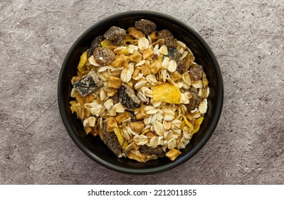 Bowl Of Muesli Isolated On Grey Concrete Background. Top Down View. Healthy Breakfast