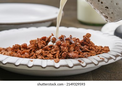 Bowl Of Muesli With Jet Milk. Breakfast Muesli Splash. Healthy Breakfast. Healthy Chocolate Granola In A Bowl. Shallow Depth Of Field