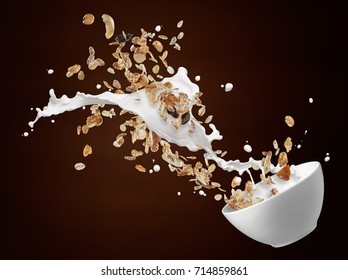 Bowl Of Muesli With Milk Splash Against Brown Background