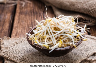 Bowl with Mungbean Sprouts on wooden background