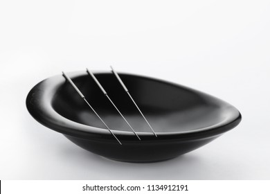 Bowl With Needles For Acupuncture On White Background