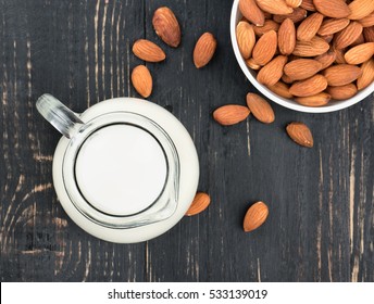 Bowl Of Nuts And Almond Milk On A Dark Table, Top View