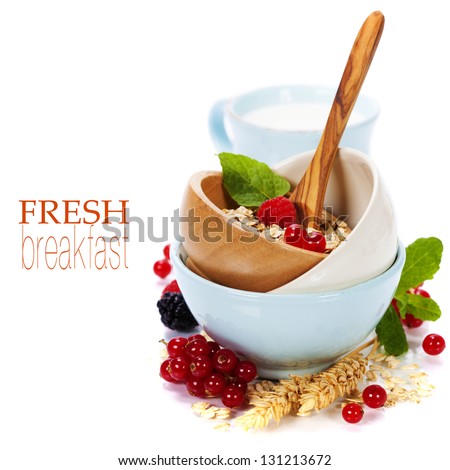 bowl of oat flake, berries and fresh milk on white background - health and diet concept (with easy removable sample text)