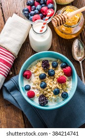 Bowl With Oat Porridge And Berry Fruits, View From Overhead On Wooden Rustic Table.