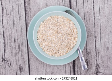  A Bowl Of Oats On A Rustic Table