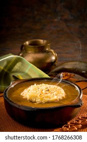 Bowl Of Onion Soup With A Napkin And A Bowl In The Background. Traditional Ecuadorian Soup In A Cozy And Warm Setup.