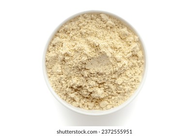 Bowl of organic Chickpea Flour (Cicer arietinum) or Gram Flour isolated on a white background, top view.