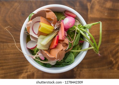 Bowl Of Organic Food Waste Like Egg Shells, Greens, And Scraps Are Ready To Go To The Compost Bin From Above