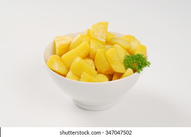 bowl of pan fried potatoes on white background
