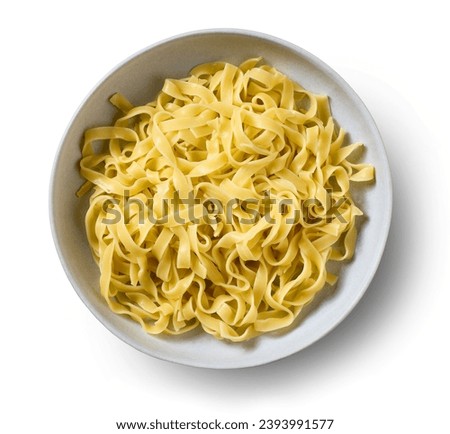 bowl of pasta tagliatelle isolated on white background, top view