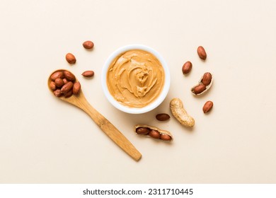 Bowl of peanut butter and peanuts on table background. top view with copy space. Creamy peanut pasta in small bowl. - Shutterstock ID 2311710445
