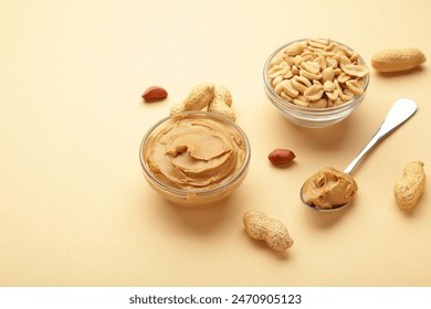 Bowl of peanut butter and peanuts on beige background. Creamy peanut pasta in small bowl. Top view - Powered by Shutterstock