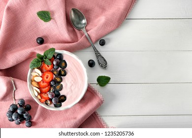 Bowl With Pink Yogurt And Fresh Fruits On White Table