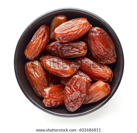 Bowl of pitted dates isolated on white background, top view