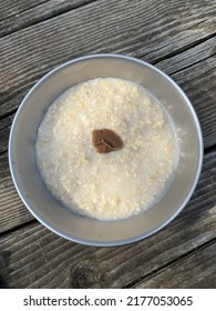 Bowl Of Plain Hot Porridge Topped With Umeboshi Plum