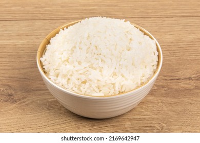 A Bowl Of Plain White Rice On A Wooden Table