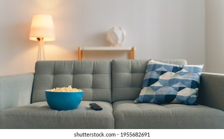 A Bowl Of Popcorn And A Path Away From The TV On The Couch In The Room.