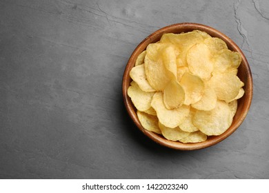 Bowl Of Potato Chips On Grey Table, Top View. Space For Text