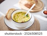 Bowl of potato soup with parsley and bacon with toasted bread croutons in white bowl. Comfort meal