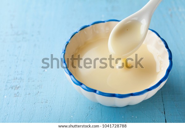 Bowl with\
pouring condensed milk or evaporated\
milk.