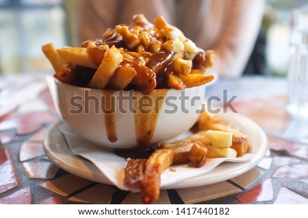 A bowl of poutine in a small French Canadian bistro 