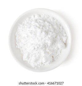 Bowl of powder sugar isolated on white background, top view