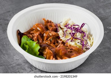 BOWL With Pulled Pork , Gravy And Cole Slaw Salad. In A Plastic Takeout Container