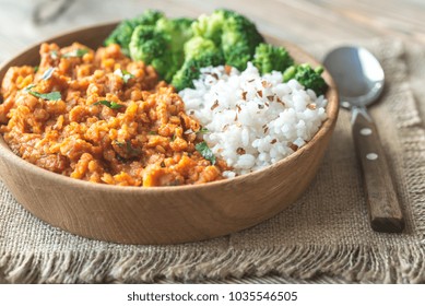 Bowl Of Red Lentil Curry With White Rice And Broccoli