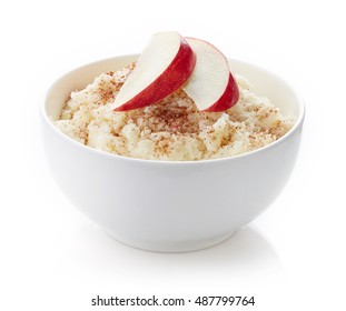 Bowl Of Rice Flakes Porridge With Apple Slices And Cinnamon Isolated On White Background