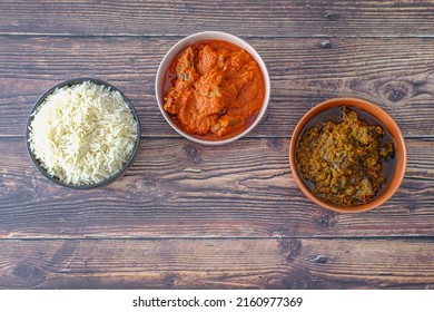 Bowl Of Rice Served With Ofada And Pepper Tomato Stew