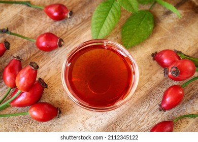 A Bowl Of Rosehip Seed Oil With Fresh Berries