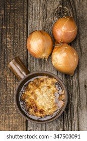 A Bowl Of Rustic Homemade French Onion Soup Photographed From Overhead.