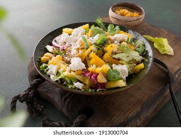 Bowl Of Salad With Feta, Corn And Pepper On A Wooden Board