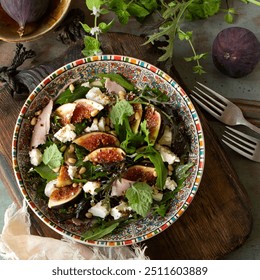 bowl of salad with prosciutto, figs and feta cheese on table, top view - Powered by Shutterstock