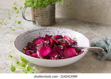 bowl with salad with radicchio, radish and baked beets on the table - Powered by Shutterstock