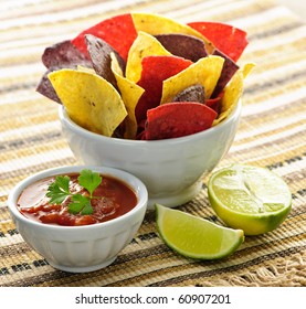 Bowl Of Salsa With Colorful Tortilla Chips And Lime