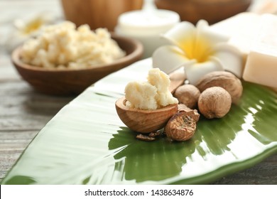 Bowl With Shea Butter, Nuts And Flower On Plate