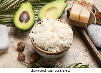 Bowl With Shea Butter, Soap And Avocado On Table, Closeup