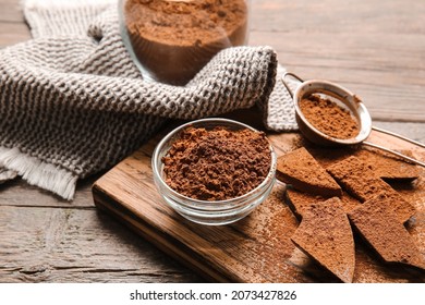 Bowl And Sieve With Cocoa Powder On Wooden Background