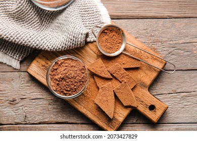 Bowl And Sieve With Cocoa Powder On Wooden Background