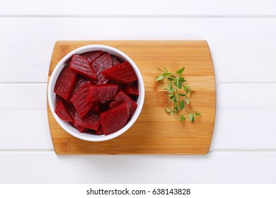 bowl of sliced and pickled beetroot on wooden cutting board - Powered by Shutterstock