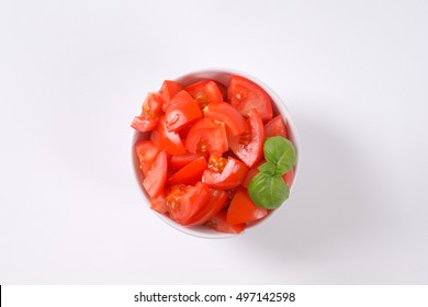 Bowl Of Sliced Ripe Tomatoes On White Background