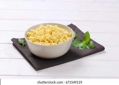 Bowl Of Small Pasta Shells On Dark Grey Place Mat