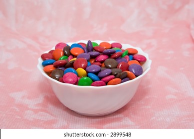 Bowl Of Smarties On Pink Background