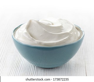 Bowl Of Sour Cream On White Wooden Table