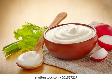 Bowl Of Sour Cream On Wooden Table